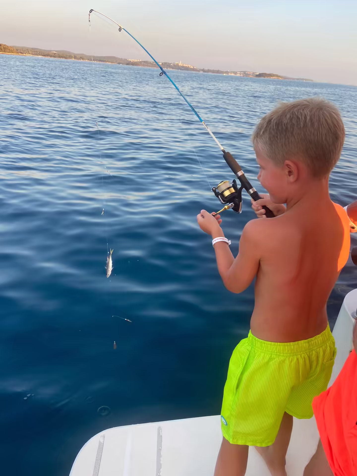Kid reeling in near Poreč coastline