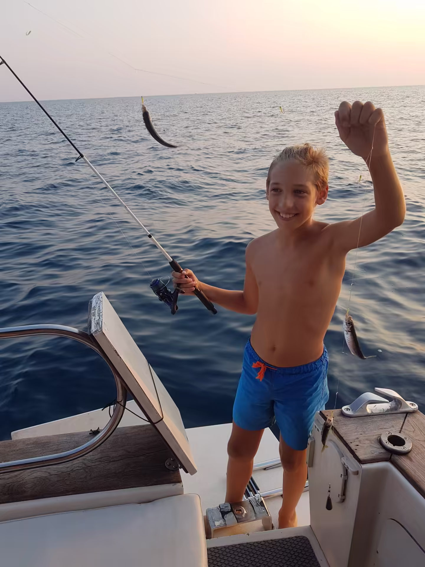 Young angler proud of his sunset catch