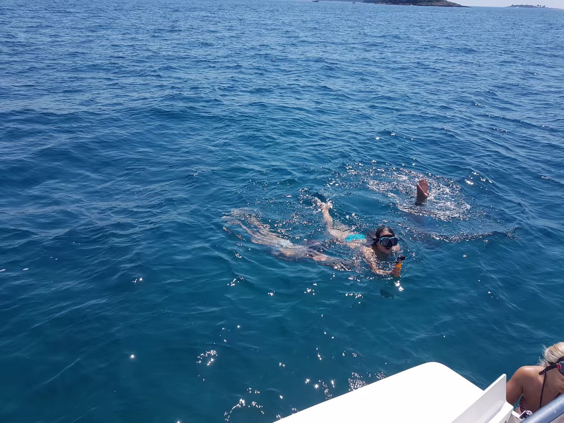 Swimmer next to the boat