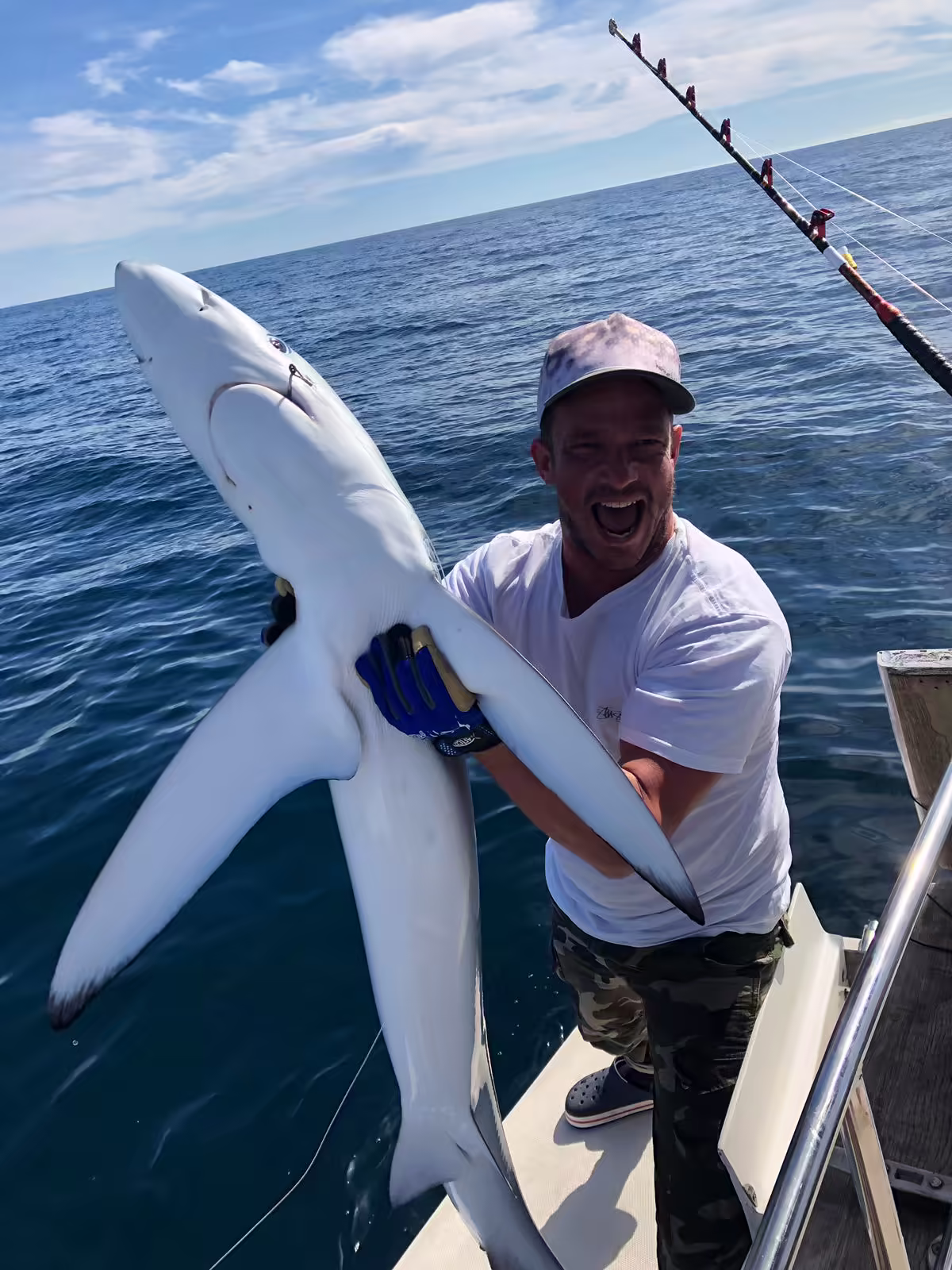 Guest with a blue shark catch offshore