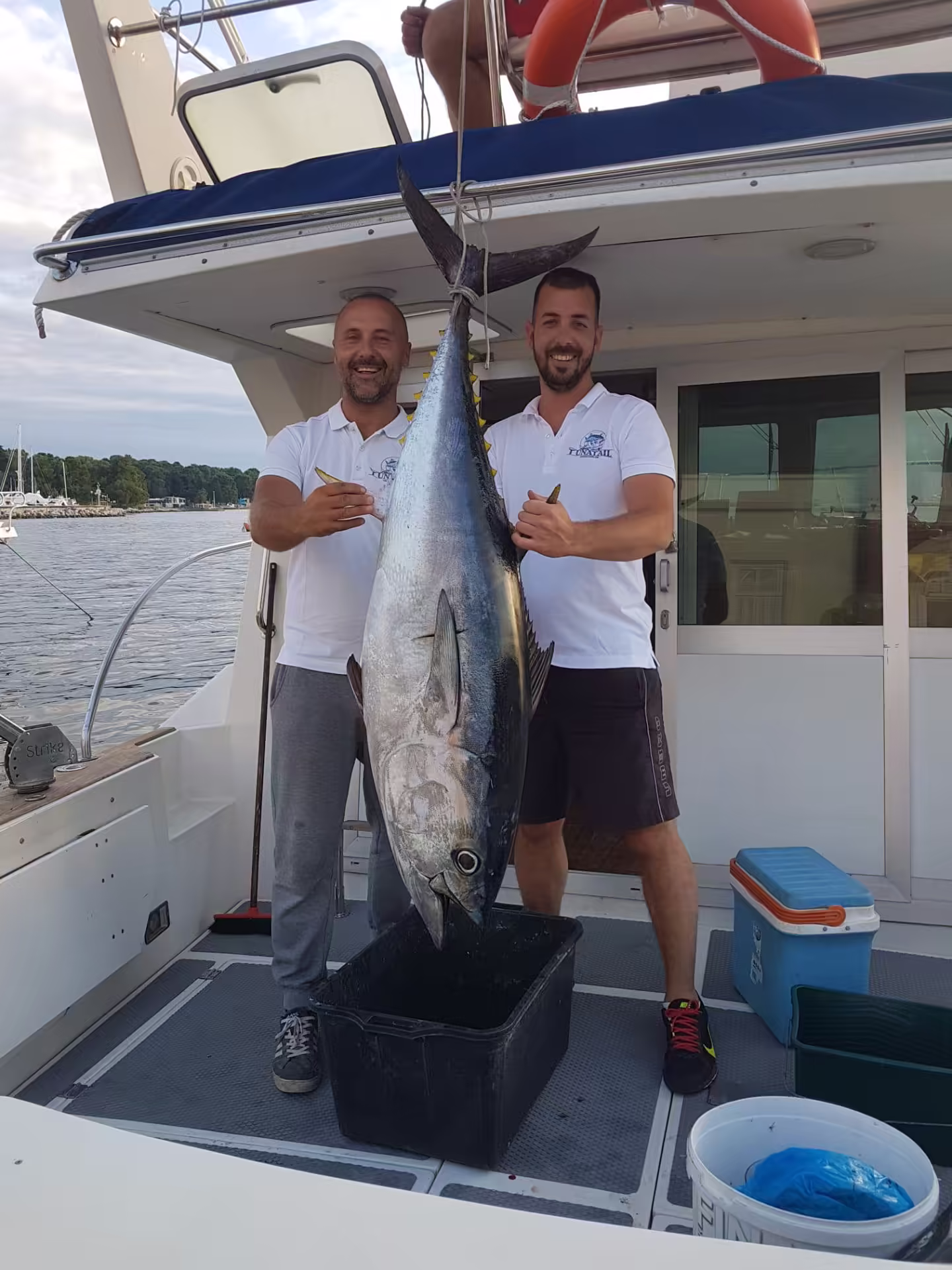 Captains presenting a Bluefin tuna aboard